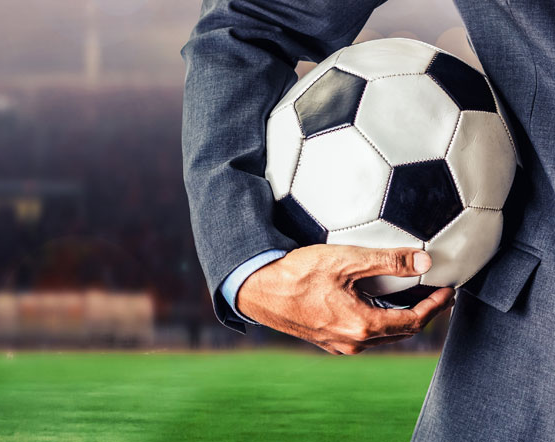 Football manager holding a ball
